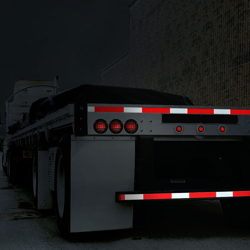 DOT-C2 conspicuity tape on a flatbed trailer at night
